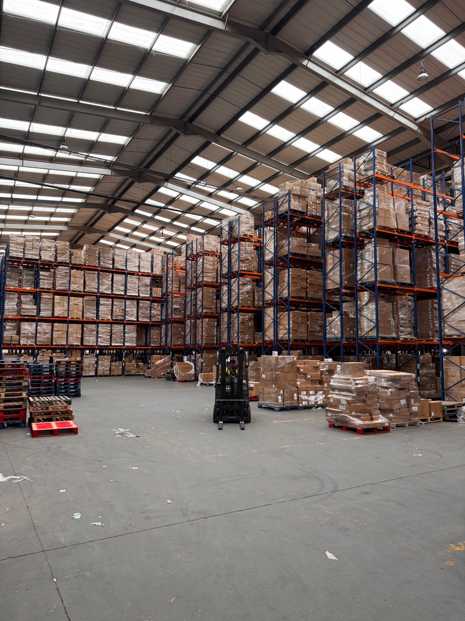 Pallet racks and forklift inside a warehouse